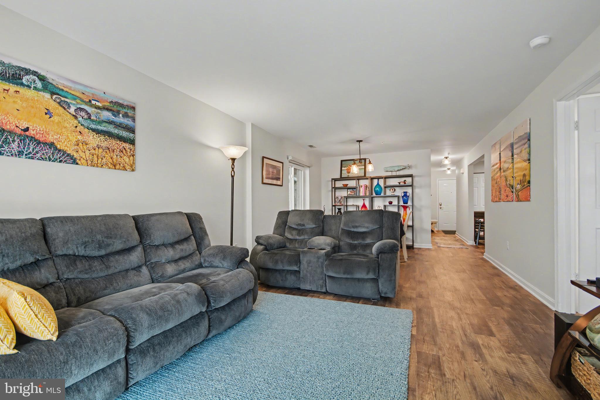 2900 Shipmaster Way, Unit 312 Annapolis, MD 21401 - Photo 14 of 56 a living room with furniture and a flat screen tv