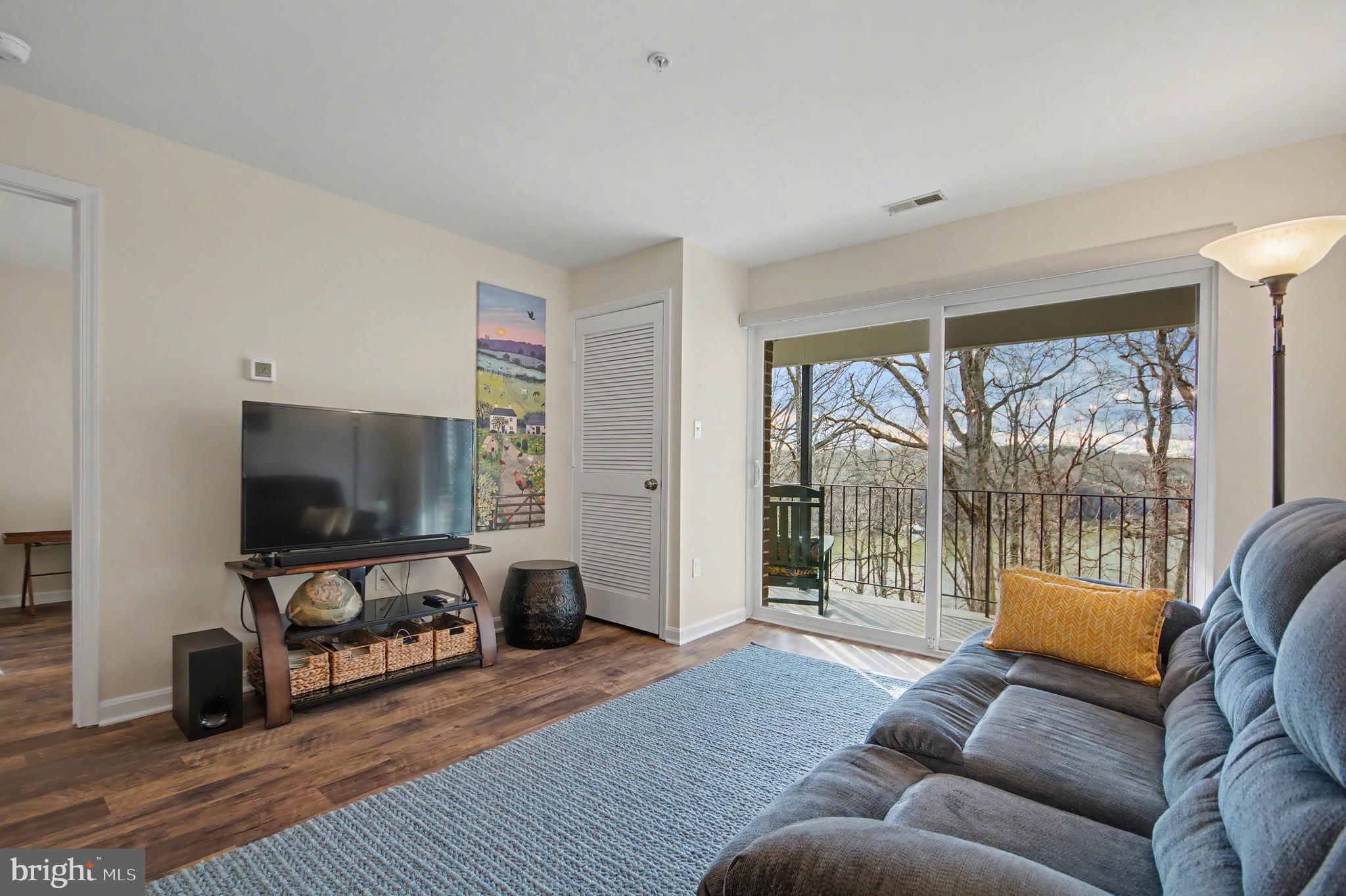 2900 Shipmaster Way, Unit 312 Annapolis, MD 21401 - Photo 15 of 56 a living room with furniture and a flat screen tv