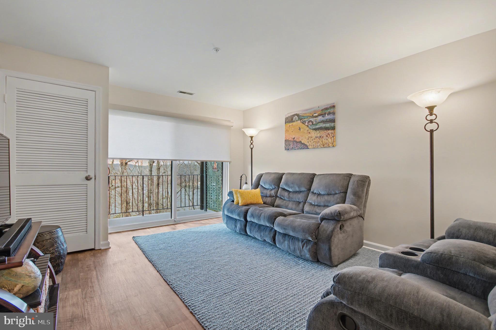 2900 Shipmaster Way, Unit 312 Annapolis, MD 21401 - Photo 16 of 56 a living room with furniture and a floor to ceiling window
