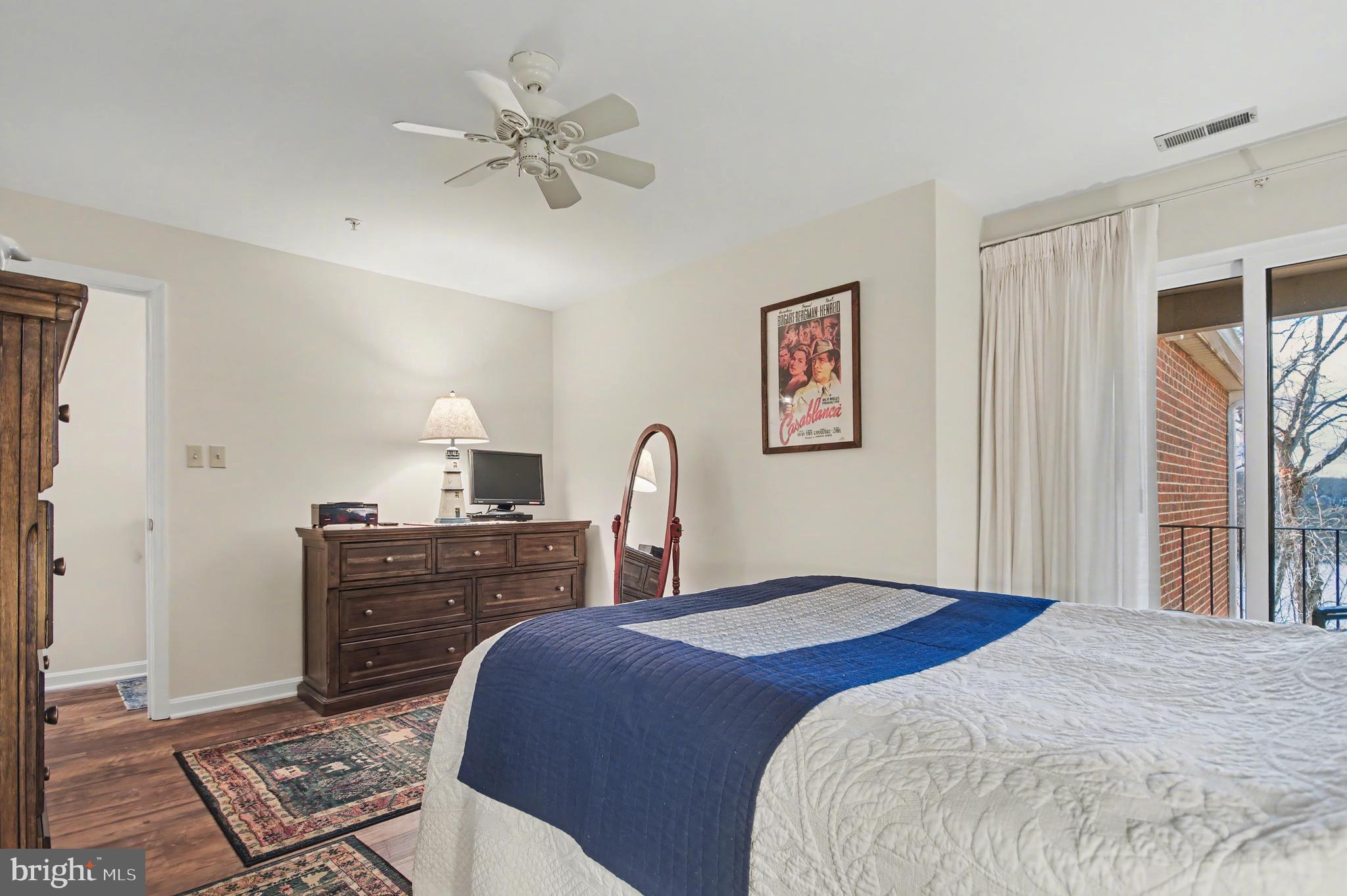 2900 Shipmaster Way, Unit 312 Annapolis, MD 21401 - Photo 18 of 56 a bedroom with a bed and a chandelier