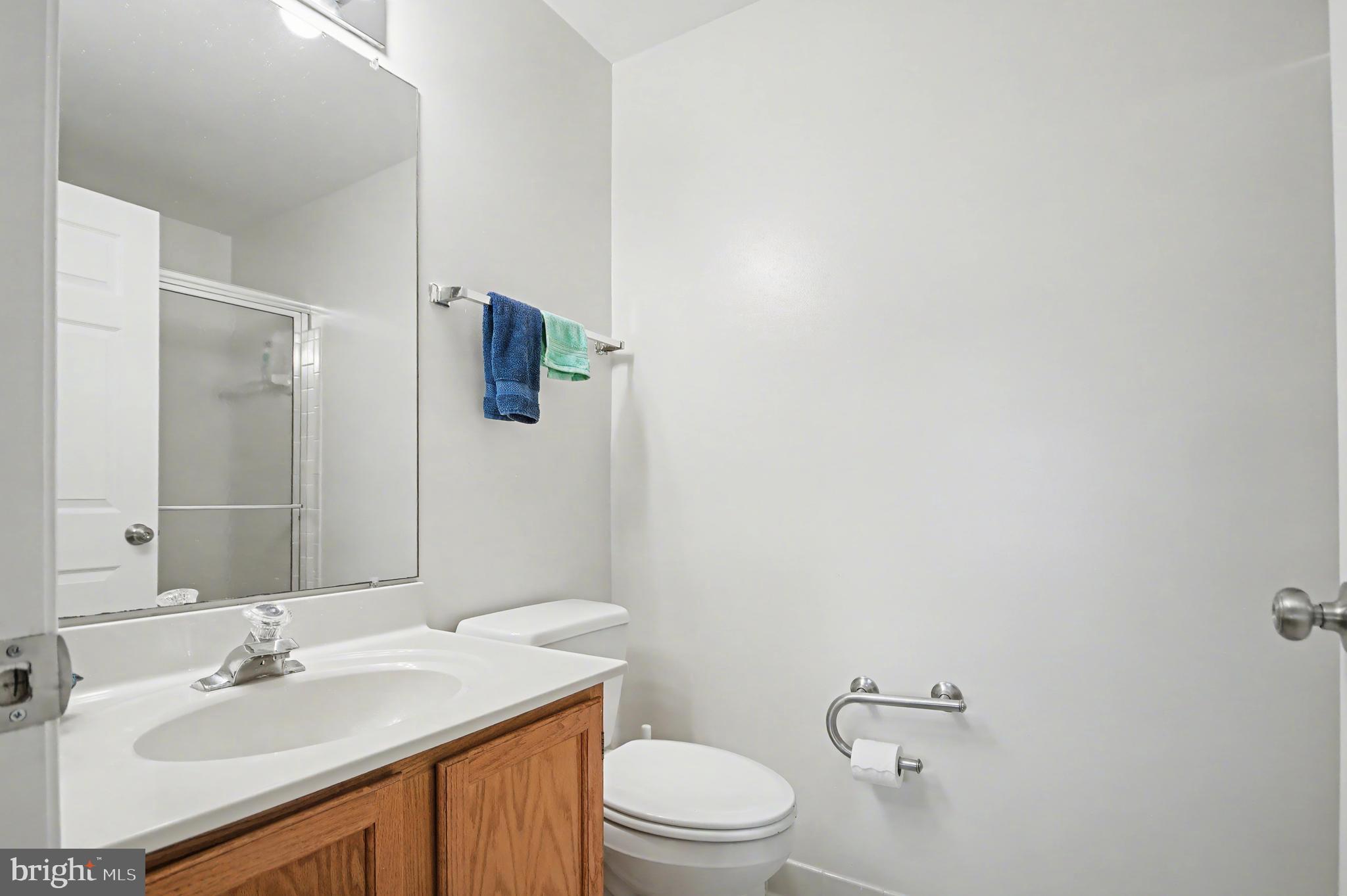 2900 Shipmaster Way, Unit 312 Annapolis, MD 21401 - Photo 21 of 56 a bathroom with a sink vanity mirror and toilet