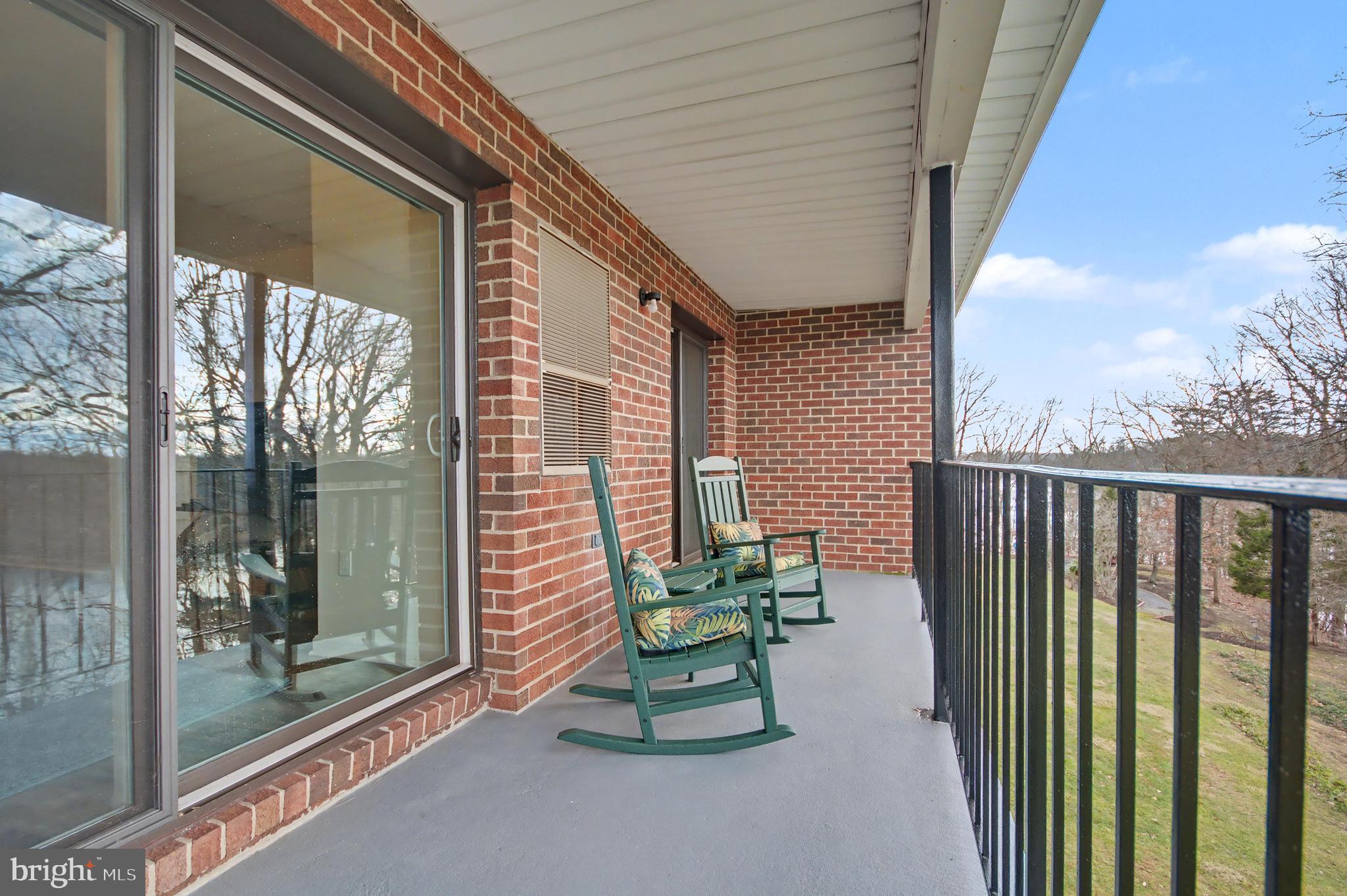 2900 Shipmaster Way, Unit 312 Annapolis, MD 21401 - Photo 27 of 56 a porch with a bench next to a yard