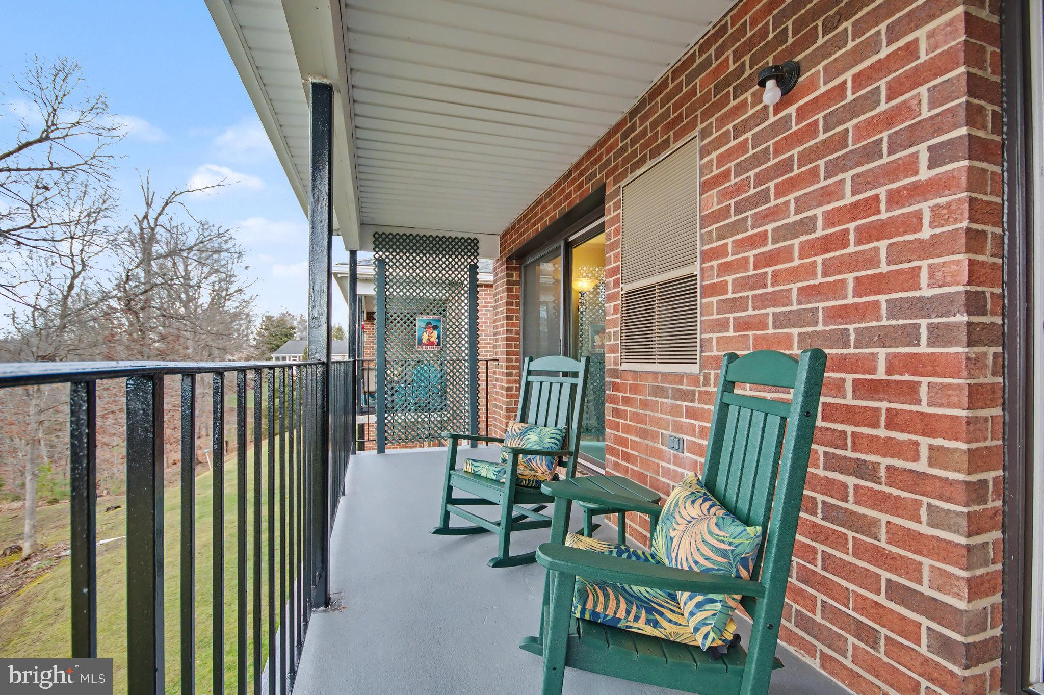 2900 Shipmaster Way, Unit 312 Annapolis, MD 21401 - Photo 28 of 56 a porch with a bench next to a yard