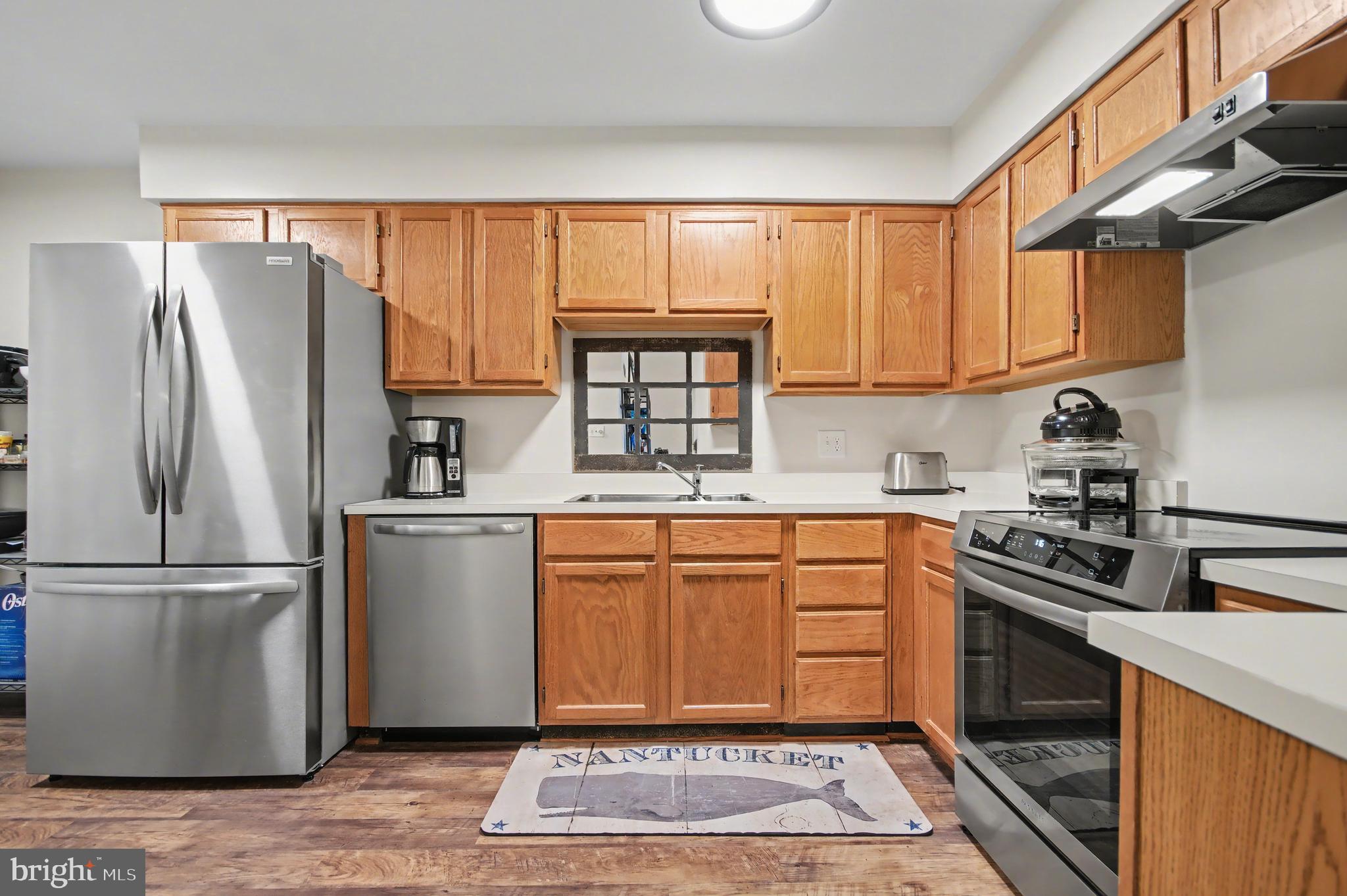 2900 Shipmaster Way, Unit 312 Annapolis, MD 21401 - Photo 4 of 56 a kitchen with stainless steel appliances granite countertop a refrigerator stove and sink