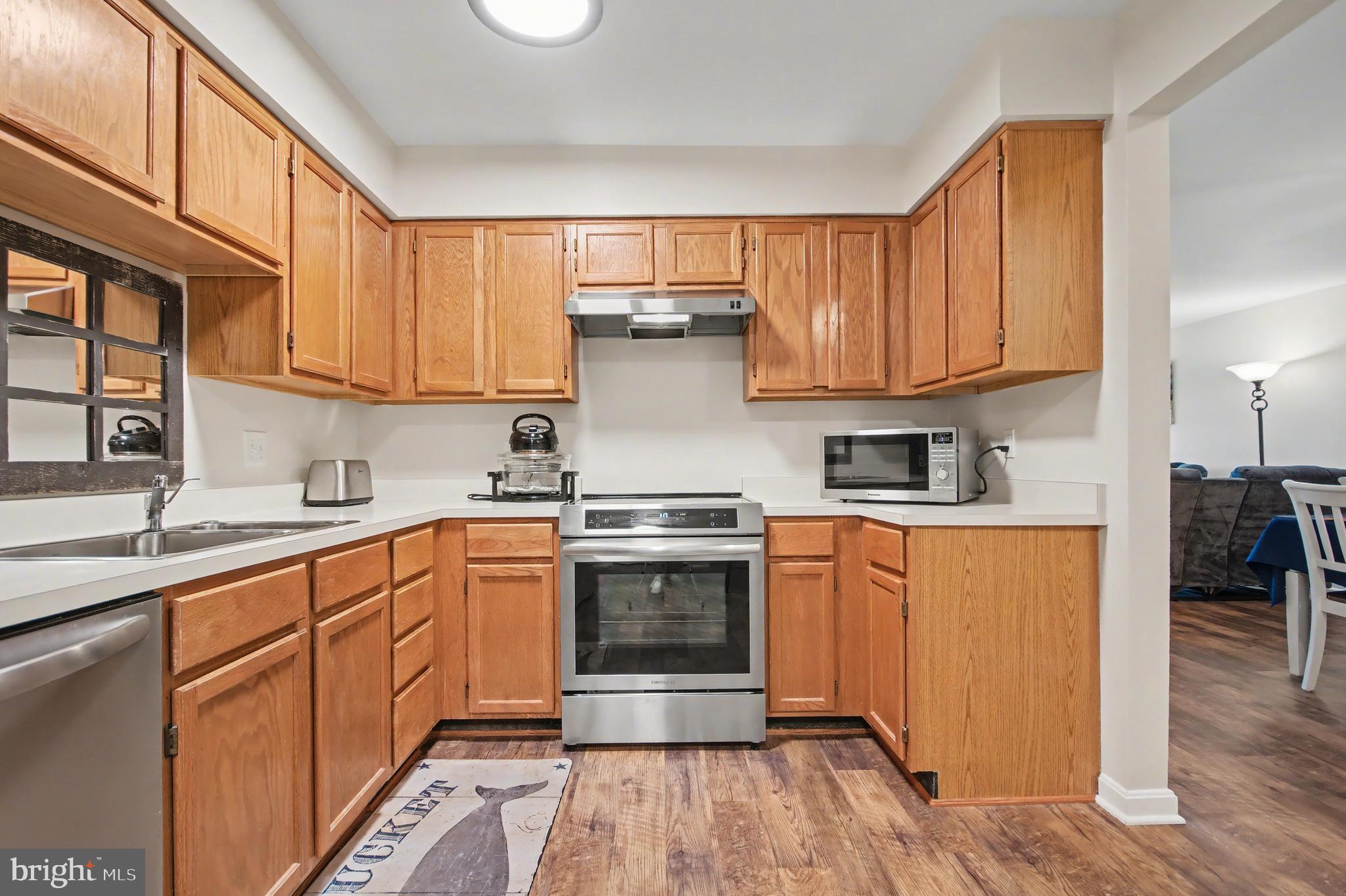 2900 Shipmaster Way, Unit 312 Annapolis, MD 21401 - Photo 5 of 56 a kitchen with stainless steel appliances granite countertop a stove and a sink
