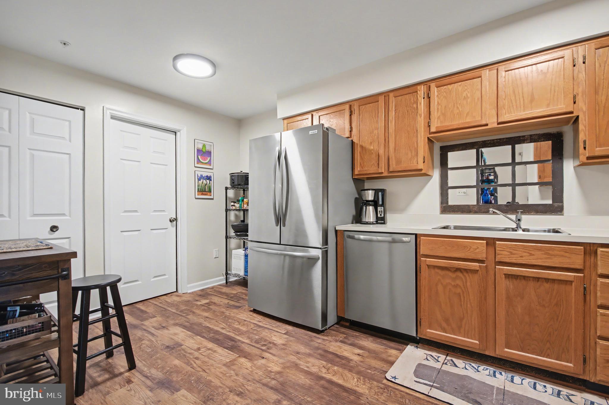 2900 Shipmaster Way, Unit 312 Annapolis, MD 21401 - Photo 7 of 56 a kitchen with stainless steel appliances granite countertop a refrigerator and a stove top oven