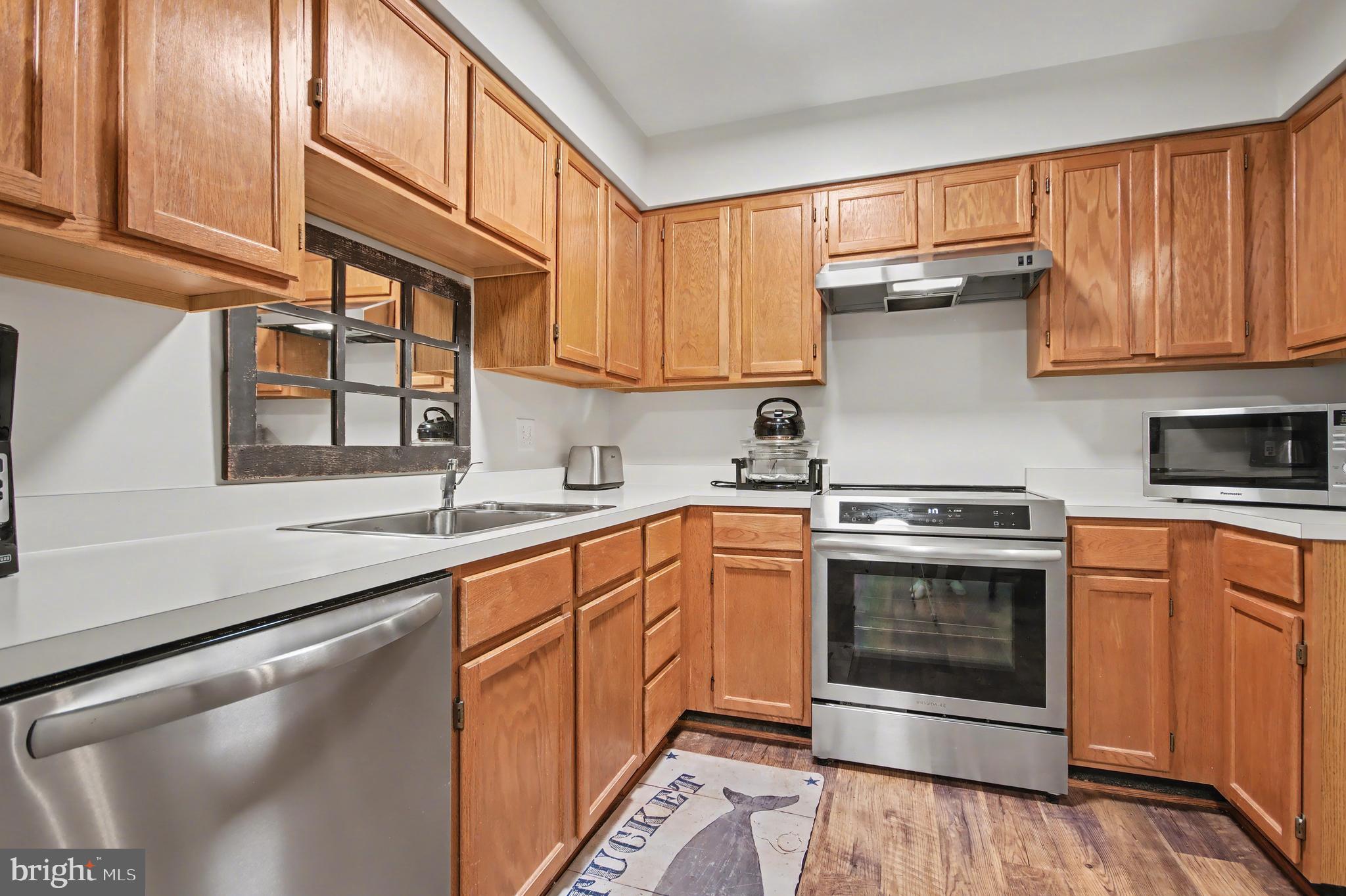 2900 Shipmaster Way, Unit 312 Annapolis, MD 21401 - Photo 8 of 56 a kitchen with stainless steel appliances granite countertop a stove a sink and a microwave