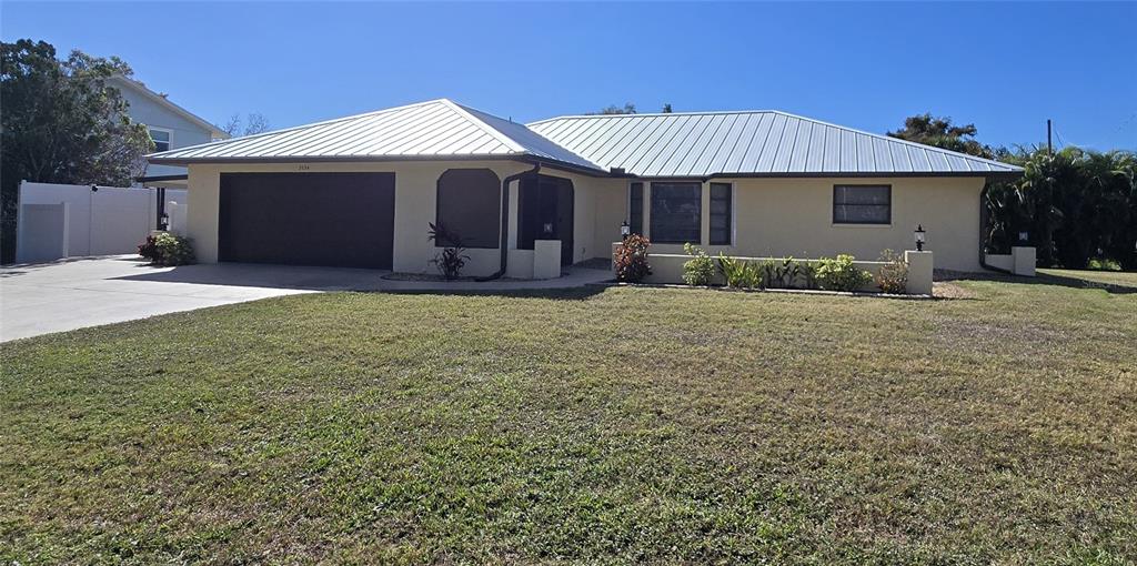 a view of a house with a yard and garage