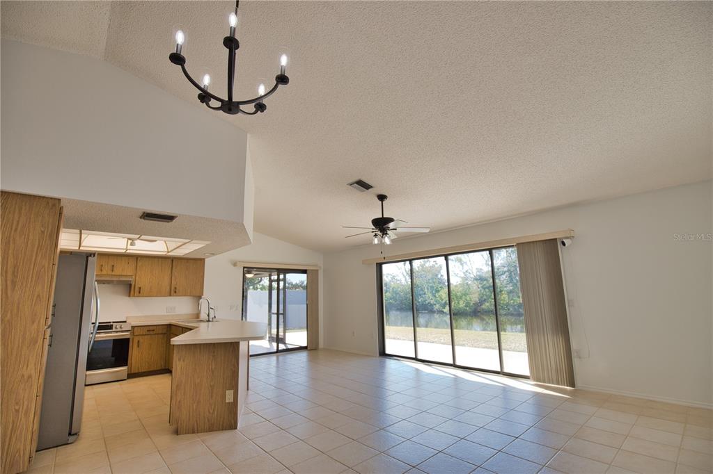 3534 Tundra Road Venice, FL 34293 - Photo 12 of 43 a view of a kitchen with a sink and dishwasher a fireplace with wooden floor