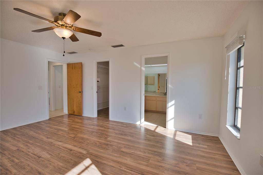 3534 Tundra Road Venice, FL 34293 - Photo 25 of 43 a view of an empty room with window and wooden floor