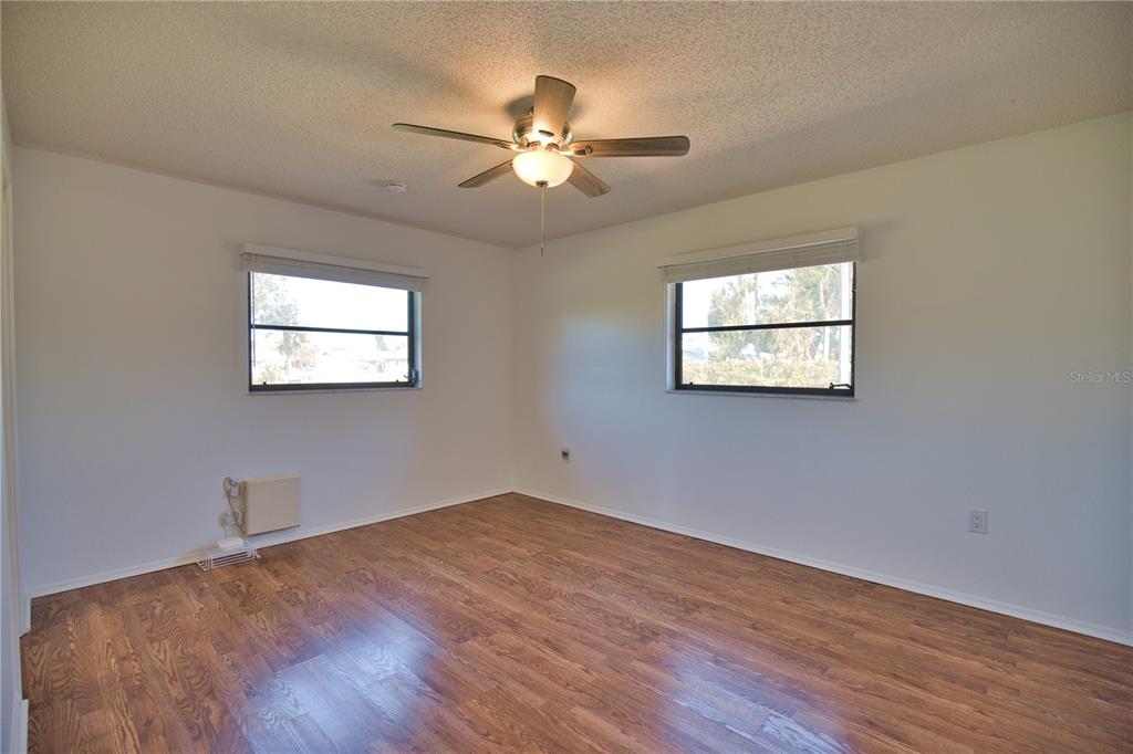 3534 Tundra Road Venice, FL 34293 - Photo 28 of 43 a view of a big room with wooden floor and windows