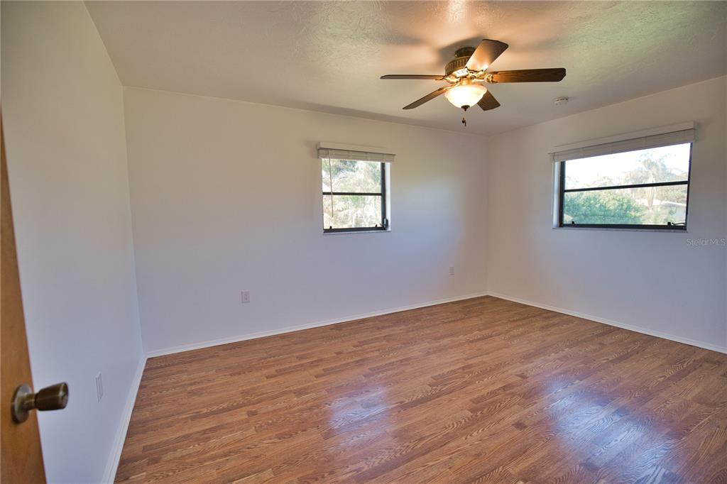 3534 Tundra Road Venice, FL 34293 - Photo 31 of 43 a view of an empty room with window and chandelier fan
