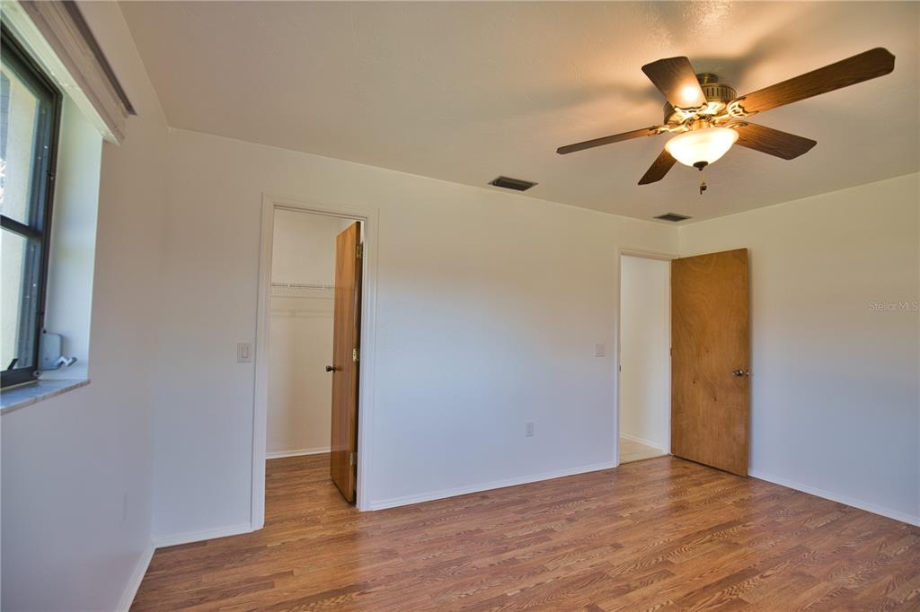3534 Tundra Road Venice, FL 34293 - Photo 32 of 43 a view of a room with wooden floor and a ceiling fan