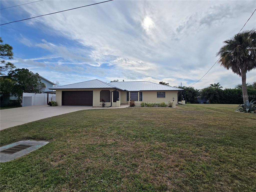 3534 Tundra Road Venice, FL 34293 - Photo 5 of 43 a front view of a house with a yard