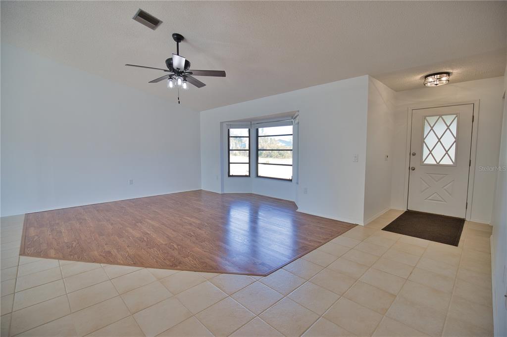 3534 Tundra Road Venice, FL 34293 - Photo 8 of 43 wooden floor in an empty room with a window