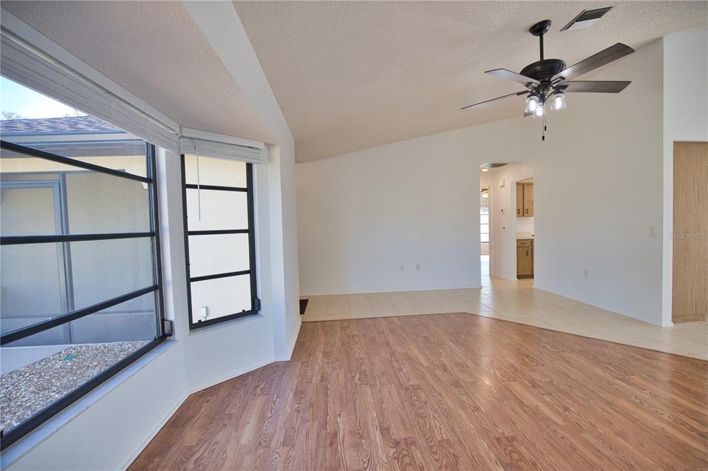 3534 Tundra Road Venice, FL 34293 - Photo 10 of 43 wooden floor in an empty room with a window