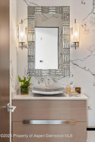 a bathroom with a sink and mirror