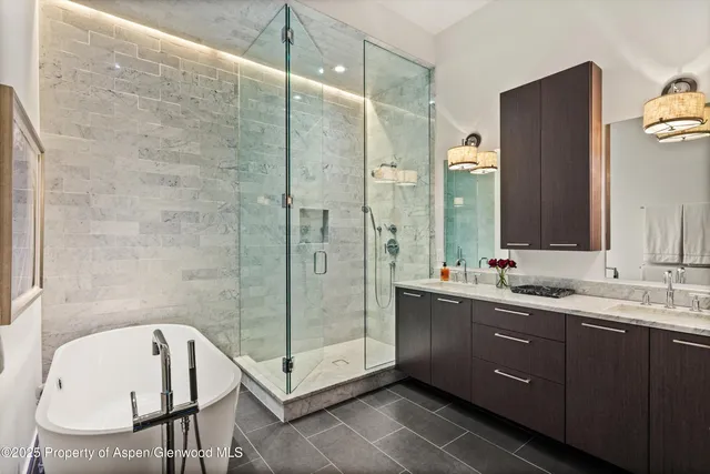 a bathroom with a tub sink and mirror