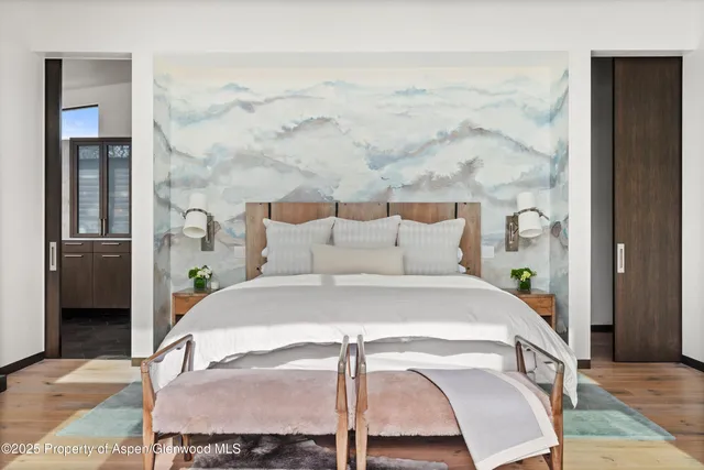 a bed sitting in a bedroom next to a bathroom