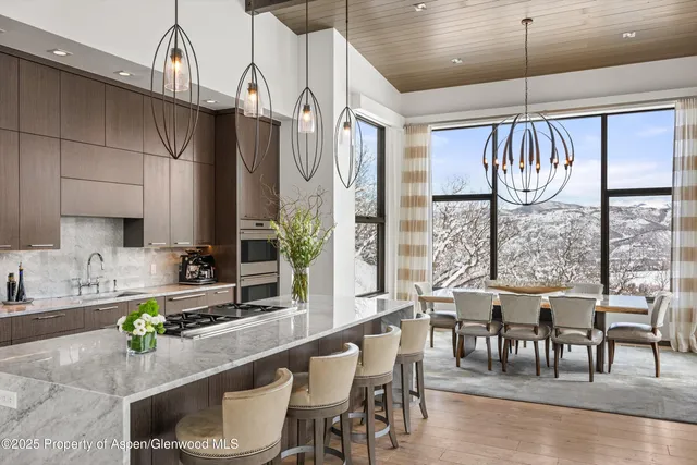 a kitchen with counter space dining table and chairs