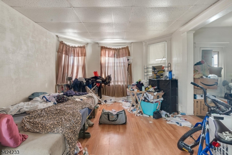 189 Scheerer Avenue Newark, NJ 07112 - Photo 12 of 30 a bedroom with furniture and a wooden floor