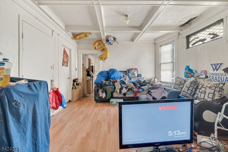 189 Scheerer Avenue Newark, NJ 07112 - Photo 16 of 30 a bedroom with furniture and a bed