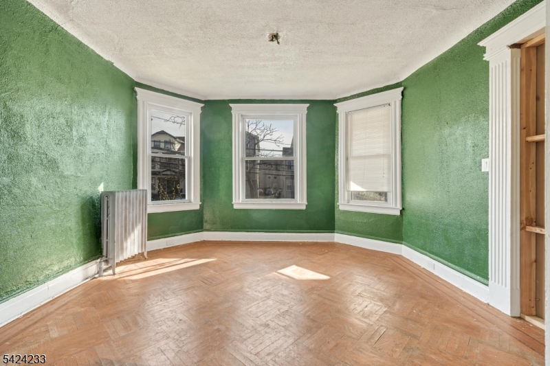 189 Scheerer Avenue Newark, NJ 07112 - Photo 2 of 30 a view of a room that has a window and brick walls