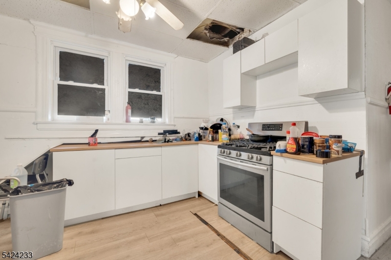 189 Scheerer Avenue Newark, NJ 07112 - Photo 10 of 30 a kitchen with stove cabinets and a sink