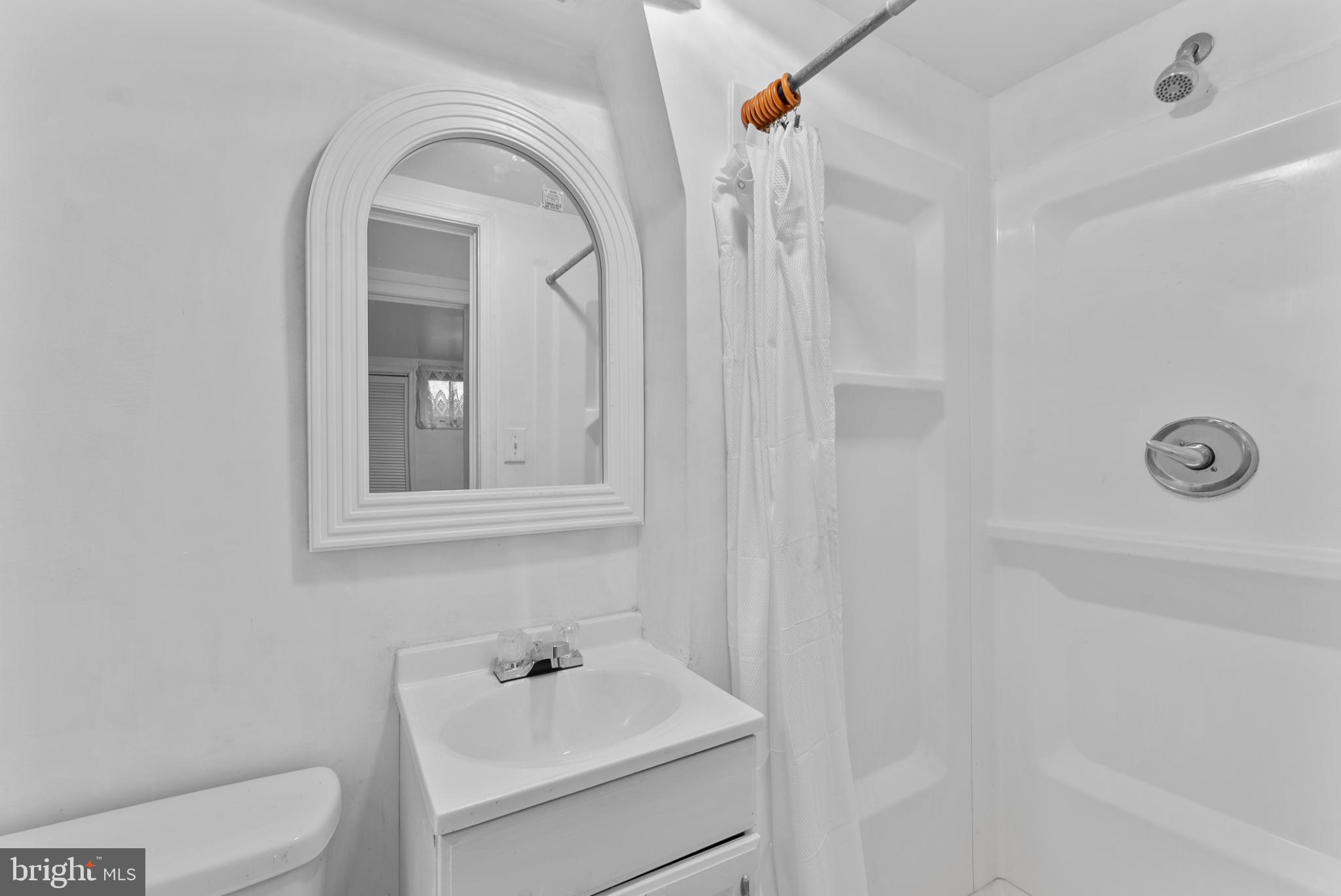 633 Walker Avenue Baltimore, MD 21212 - Photo 17 of 27 a bathroom with a sink a toilet and a mirror