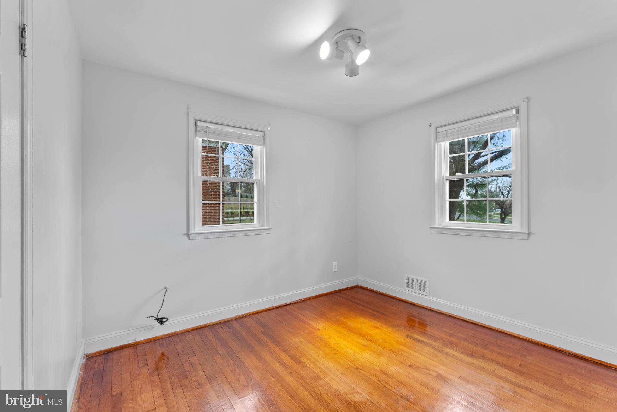 633 Walker Avenue Baltimore, MD 21212 - Photo 22 of 27 a view of an empty room with a window and wooden floor