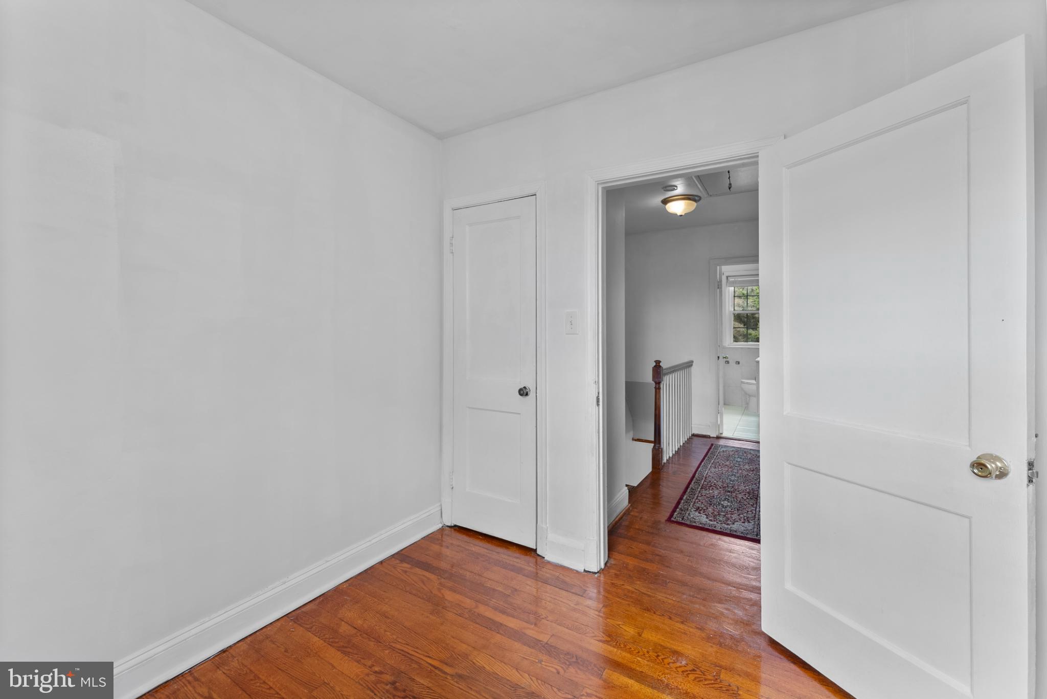 633 Walker Avenue Baltimore, MD 21212 - Photo 23 of 27 a view of a hallway with wooden floor and staircase