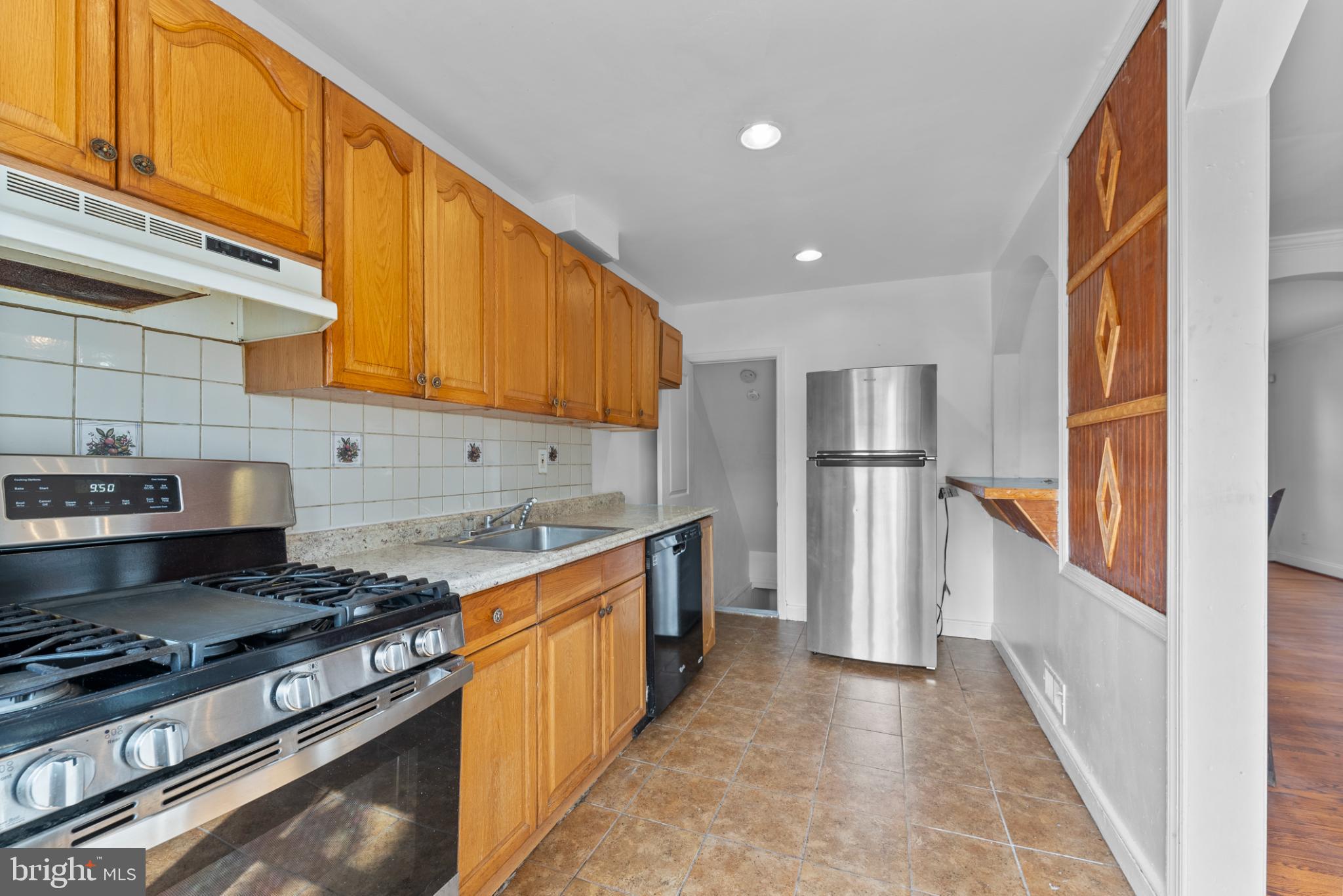 633 Walker Avenue Baltimore, MD 21212 - Photo 7 of 27 a kitchen with stainless steel appliances granite countertop a stove a sink and a refrigerator