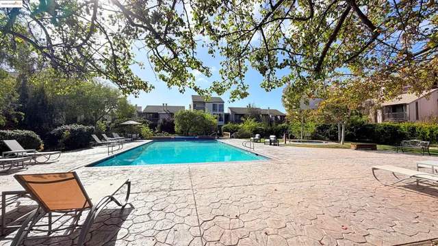 a view of a swimming pool with an outdoor seating