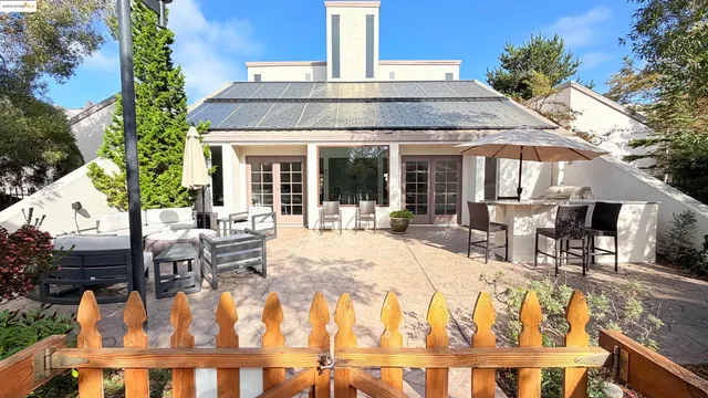 a view of a bedroom with wooden floor and windows