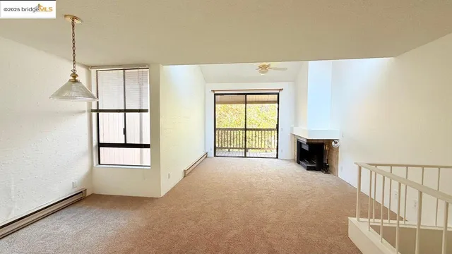 a view of empty room with a fireplace