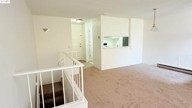 a kitchen with granite countertop white cabinets and refrigerator