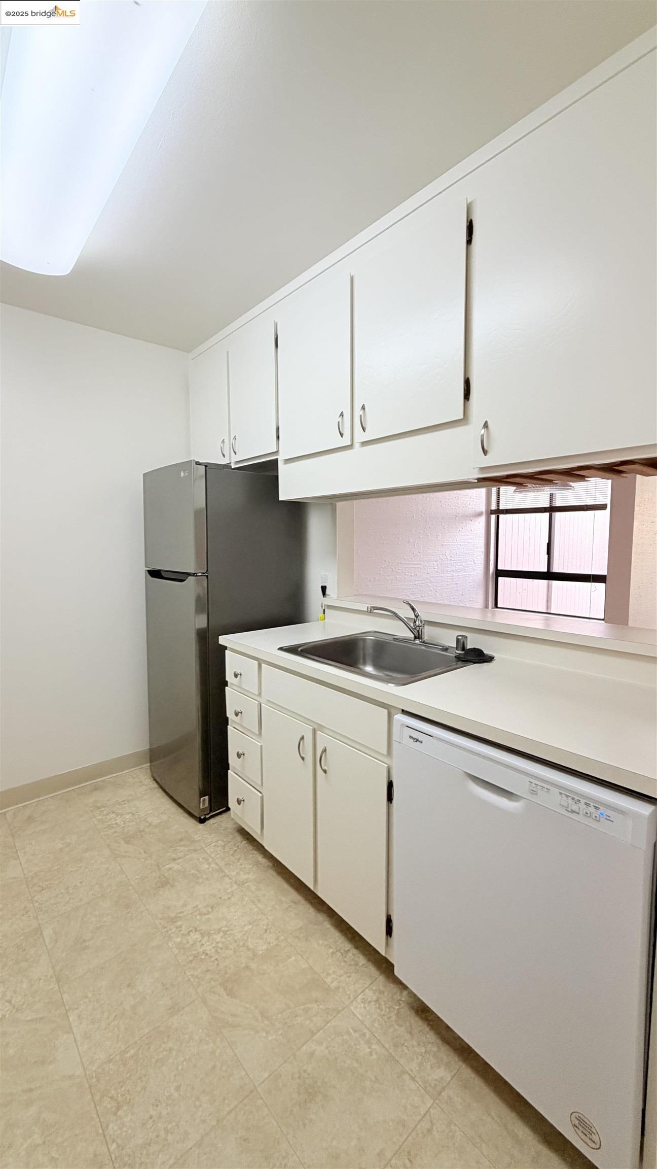 2101 Shore Line Drive, Unit 265 Alameda, CA 94501 - Photo 20 of 34 a kitchen with granite countertop white cabinets and refrigerator