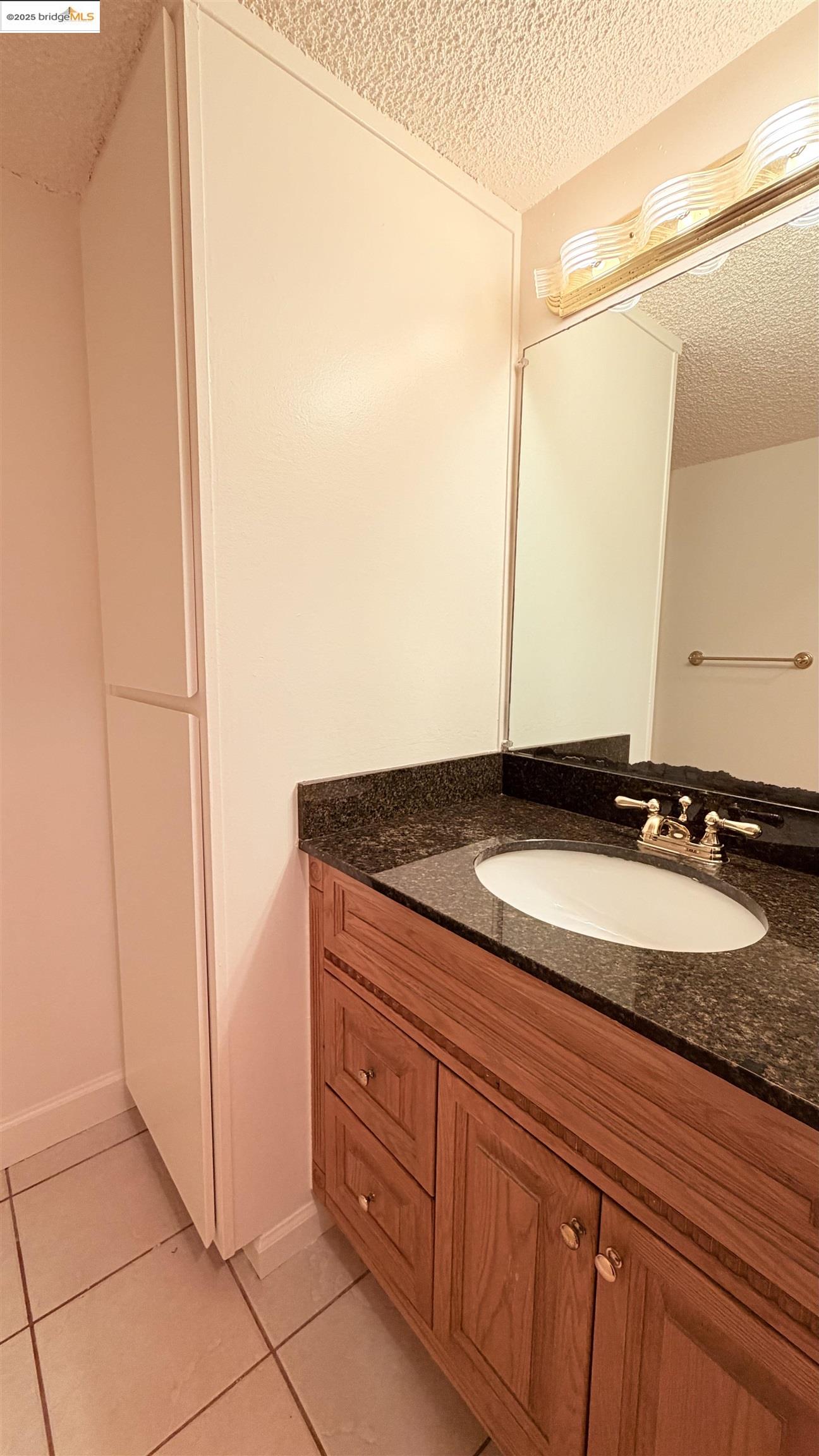 2101 Shore Line Drive, Unit 265 Alameda, CA 94501 - Photo 26 of 34 a bathroom with a granite countertop sink and a mirror