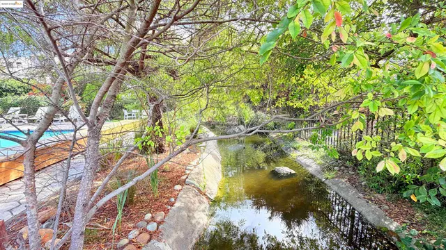 a swimming pool with outdoor seating and yard
