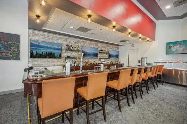 a dining table with chairs and window