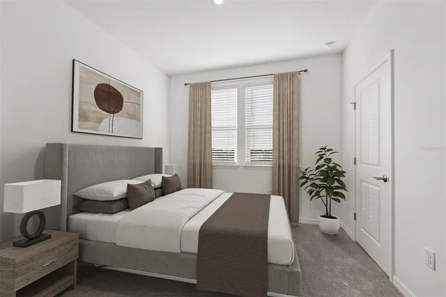 a bedroom with a bed and potted plant