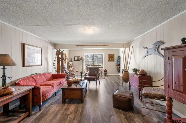 a kitchen with stainless steel appliances granite countertop a stove a sink dishwasher and a refrigerator with wooden floor