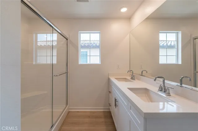 a bathroom with 2 sink and a window
