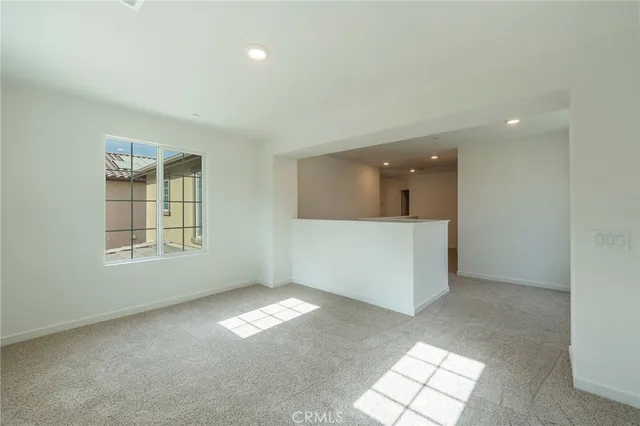 an empty room with windows and entrance