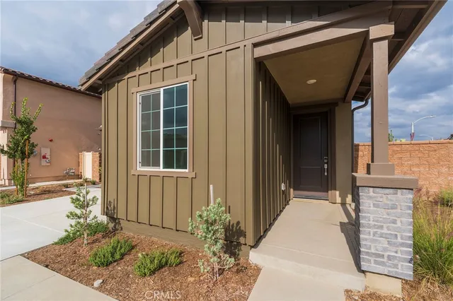 a view of a house with a potted plant and floor to ceiling window and potted plants