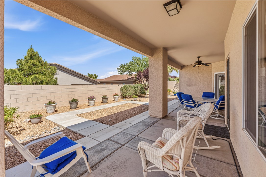 3315 Rainbow Mine Road Kingman, AZ 86401 - Photo 39 of 54 The property features a covered patio with a ceiling fan, concrete flooring, and an exterior wall