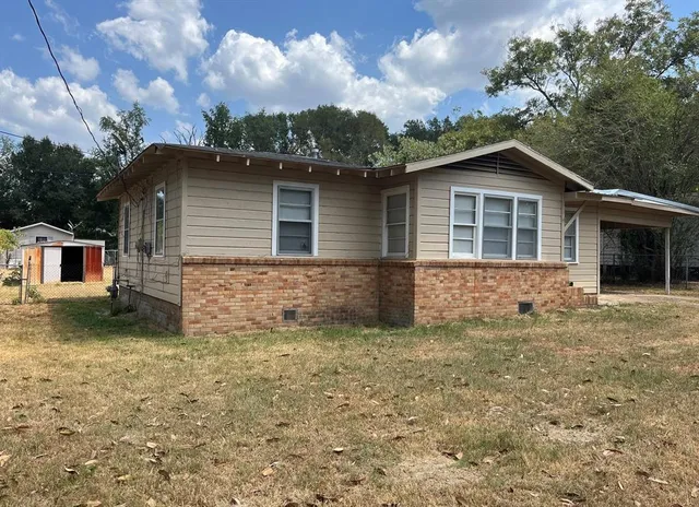 a house that has a tree in front of it