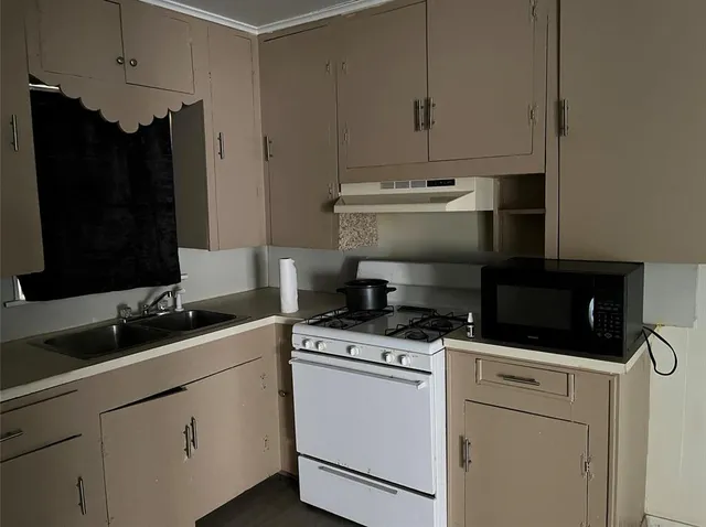 a kitchen with appliances cabinets and a sink
