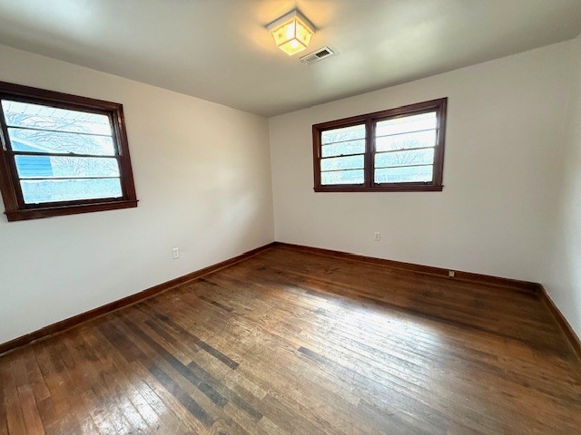501 Corning Street Anderson, SC 29624 - Photo 5 of 9 This inviting room features warm wood flooring and ample natural light, creating a comfortable living space.