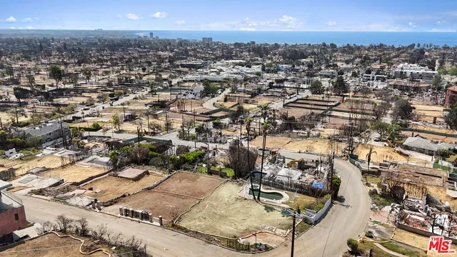 an aerial view of a residential houses with outdoor space